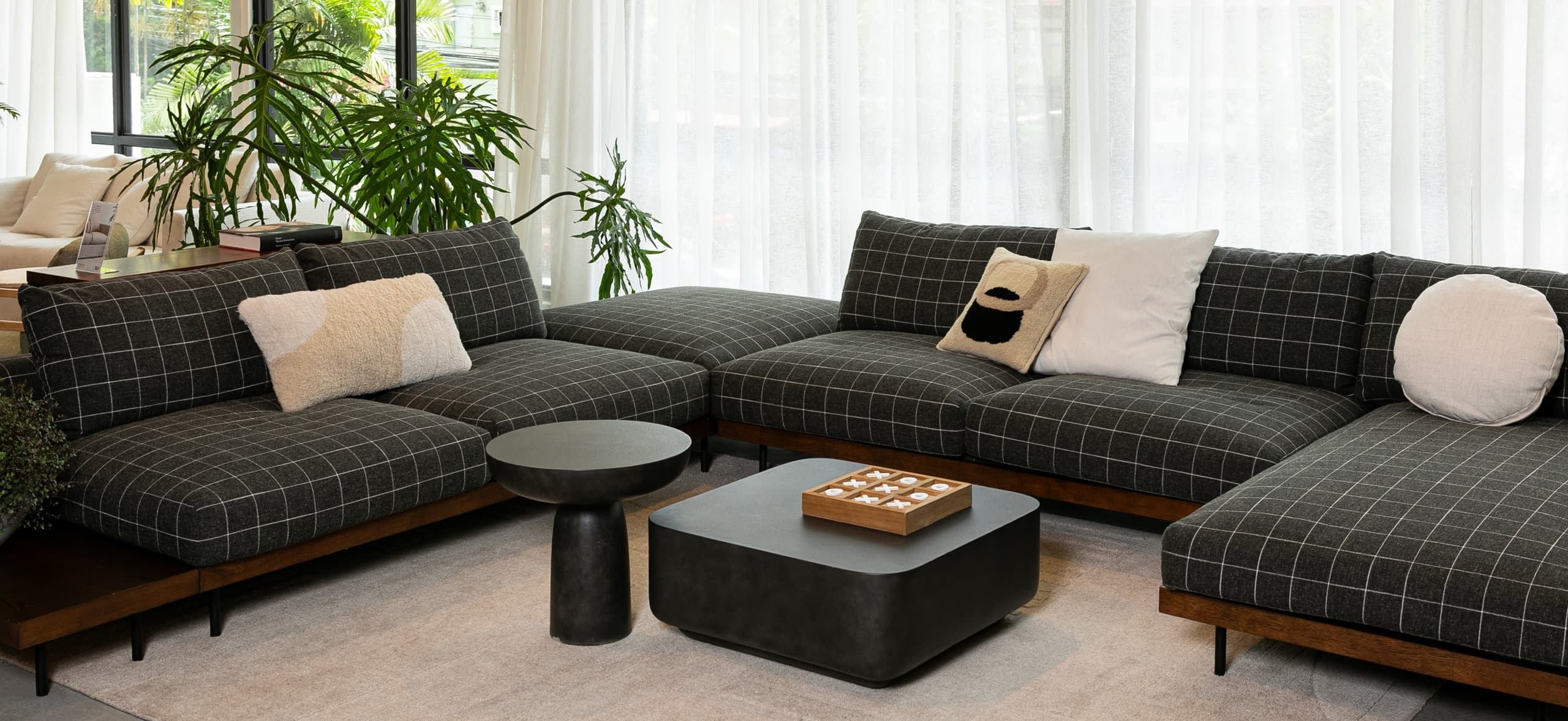 The Sabi sofa from Mansa Furniture upholstered in canvas fabric with a grid pattern made from a blend of natural and synthetic yarns